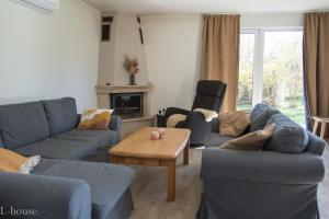 a living room with blue couches and a coffee table at Vacation house in Saulkrasti