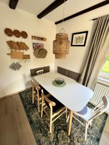 a dining room with a white table and chairs at FerienChata Bärenriegel in Arrach