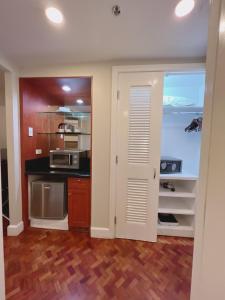 a kitchen with a sink and a microwave at Olympia Makati Studio former Somerset Olympia Makati in Manila