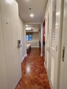 a hallway with a door and a room with a floor at Olympia Makati Studio former Somerset Olympia Makati in Manila