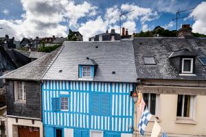 a blue and white building with a gray roof at Cosy loft - plein centre d'Honfleur in Honfleur