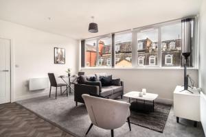 a living room with a couch and a table at Modern 1 Bed Apartment in Central Wrexham in Wrexham