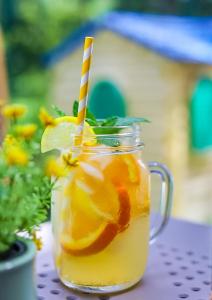 a mason jar filled with orange juice with two paper straws at Pomorze Health & Family Resort in Ustka