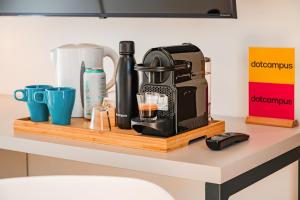 a coffee maker on a wooden shelf on a counter at Dotcampus Roma City Center in Rome