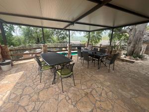 a patio with tables and chairs under a tent at Luxury house Ivan with 4 bedrooms in Divojevići