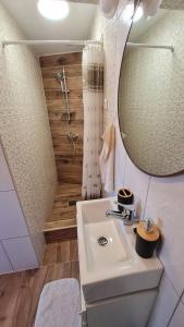 a bathroom with a sink and a mirror at Apartments Valentina Tisno in Tisno +110 photos