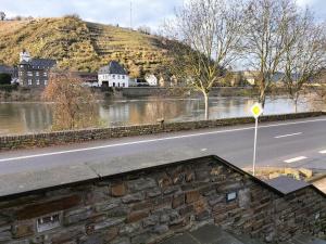 a road next to a river next to a mountain at B3 Hotel in Niederfell