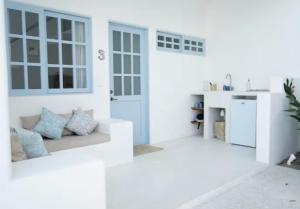a white room with a door and a couch at Punta Mayia in Brisas de Zicatela