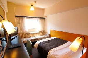 Postel nebo postele na pokoji v ubytování Hotel Listel Shinjuku + 31 fotografií