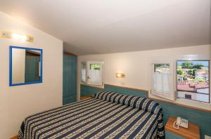 Postel nebo postele na pokoji v ubytování Hotel Apuana