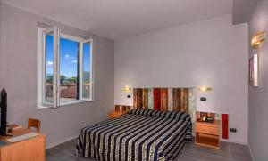 Postel nebo postele na pokoji v ubytování Hotel Apuana