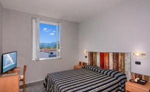 Postel nebo postele na pokoji v ubytování Hotel Apuana