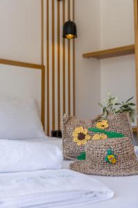 a bed with a pillow with a flower on it at Kalkan Beach Park Hotel in Kas