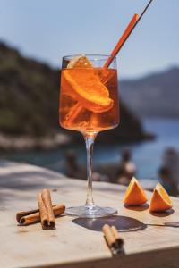 a drink on a table with an orange slice at Kalkan Beach Park Hotel in Kas