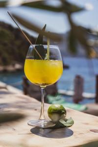 a glass of orange juice and a lime on a table at Kalkan Beach Park Hotel in Kas