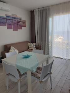 a living room with a table and chairs and a couch at Samy house in Castelsardo