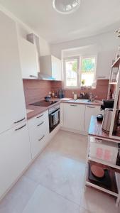 a white kitchen with white cabinets and a sink at Nisay Home - City House - Central Location - 5 Rooms in Ludwigsburg +27 photos