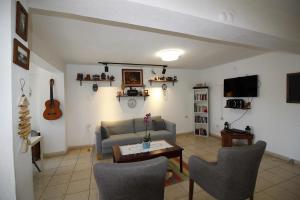 a living room with a couch and a table at Bonapart Hotel in Çeşme