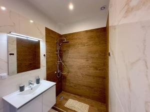 a bathroom with a white sink and a shower at Rodia 1 in Pteleos +34 photos