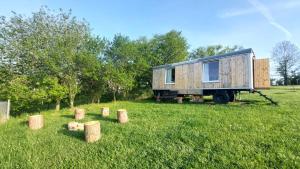 a tiny house on a trailer in a field at Maringotka Ovčárka in Čestín