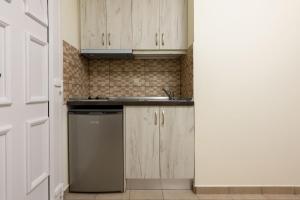 a kitchen with a sink and a dishwasher at Villa Roula in Koinyra