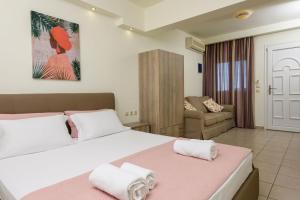 a bedroom with a large bed and a couch at Villa Roula in Koinyra