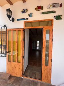 an open door to a room with surfboards on the wall at Casita rural La cometa in Ruidera +12 photos