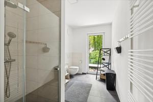 a bathroom with a shower and a toilet at Sali-Homes R5 - New Build with Terrace in City Center in Bayreuth +18 photos