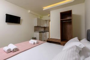 a bedroom with a large bed with towels on it at Villa Roula in Koinyra