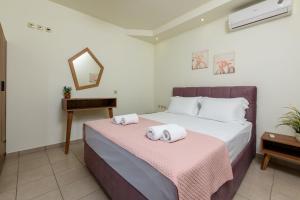 a bedroom with a bed with towels on it at Villa Roula in Koinyra