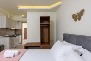 a bedroom with a bed with a butterfly on the wall at Villa Roula in Koinyra
