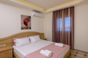 a bedroom with a bed with two towels on it at Villa Roula in Koinyra