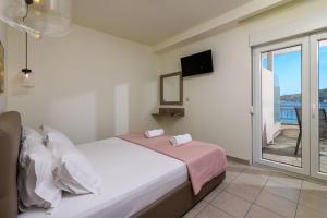 a bedroom with a bed and a window with a view at Villa Roula in Koinyra