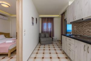 a bedroom with a bed and a chair in a room at Villa Roula in Koinyra
