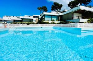 a large swimming pool in front of a house at Canido Beach 6 by YBH in Vigo
