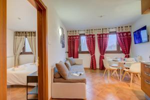 a living room with a couch and a table at L' Aquila Campo Smith On The Ski Slopes - Happy Rentals in Bardonecchia +11 photos