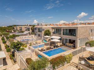 an aerial view of a building with a swimming pool at Villa Calla ZadarVillas in Petrcane