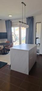 a kitchen with a white island in a living room at Vitas Apartments in Zaton