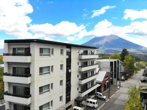 an apartment building with a view of a mountain at The Freshwater in Niseko