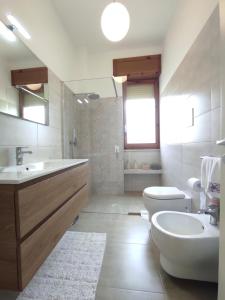 a bathroom with a sink and a toilet and a tub at Dimora Zoe sea view by CASASI Vacanze Otranto in Otranto +33 photos