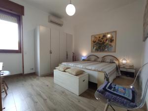 a bedroom with a bed and a desk and a chair at Dimora Zoe sea view by CASASI Vacanze Otranto in Otranto