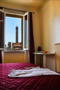a hotel room with a bed and a window at B&B Casa Faccioli in Bologna