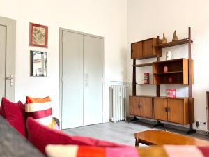 a living room with a red couch and a cabinet at ComeCasa Turin Nest 2 Bedroom Comfort in Turin