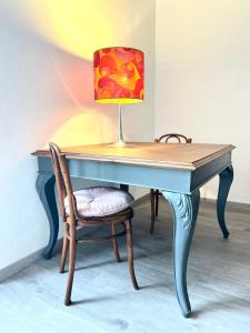 a lamp on top of a desk with a chair at ComeCasa Turin Nest 2 Bedroom Comfort in Turin