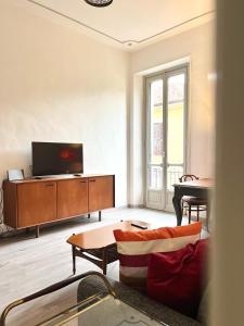 a living room with a television and a piano at ComeCasa Turin Nest 2 Bedroom Comfort in Turin