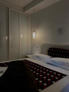 a bedroom with a bed and a cabinet at Hotel CineApollo - Ogni camera un film! in Messina