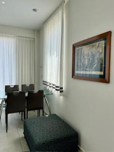 a dining room with a table and chairs and a picture at Hotel CineApollo - Ogni camera un film! in Messina