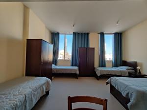 Postel nebo postele na pokoji v ubytování Oasis Hostel