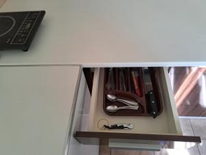 a drawer in a white cabinet filled with tools at Anthony in Niš