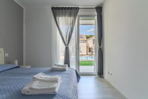 Posteľ alebo postele v izbe v ubytovaní Le Dune Verdi